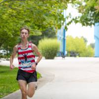 Participant running through campus